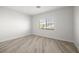 This light and airy bedroom has wood-look floors and a large window at 9491 Gainey Ranch Ave, Las Vegas, NV 89147