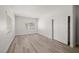 Bright bedroom with wood-look flooring, window, and closet with sliding doors at 9491 Gainey Ranch Ave, Las Vegas, NV 89147