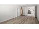 Cozy bedroom with wood-look flooring, sliding door closet, and neutral paint at 9491 Gainey Ranch Ave, Las Vegas, NV 89147