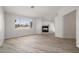 Spacious bedroom features wood-style flooring, bright window and stone-clad fireplace at 9491 Gainey Ranch Ave, Las Vegas, NV 89147