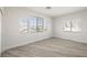 This bedroom offers natural light from multiple windows and wood-look floors at 9491 Gainey Ranch Ave, Las Vegas, NV 89147