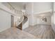 Spacious foyer featuring a curved staircase, tile flooring, and an open floor plan at 9491 Gainey Ranch Ave, Las Vegas, NV 89147