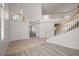 Bright, open foyer showcasing a curved staircase and tile flooring at 9491 Gainey Ranch Ave, Las Vegas, NV 89147