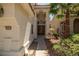Elegant front entry with double doors, desert landscaping, and exterior lighting at 9491 Gainey Ranch Ave, Las Vegas, NV 89147
