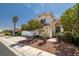 Inviting two-story home featuring a tile roof, three-car garage, and desert landscaping at 9491 Gainey Ranch Ave, Las Vegas, NV 89147