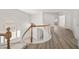 Bright hallway features wood-style flooring, white walls and white railings around staircase at 9491 Gainey Ranch Ave, Las Vegas, NV 89147