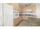 Kitchen with white appliances, plenty of cabinets and a granite island at 9491 Gainey Ranch Ave, Las Vegas, NV 89147