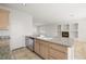 Open kitchen island with granite countertop, sink, dishwasher and views to living room at 9491 Gainey Ranch Ave, Las Vegas, NV 89147