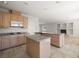 Open kitchen showcasing a spacious island with granite countertops, ample cabinet storage, and appliances at 9491 Gainey Ranch Ave, Las Vegas, NV 89147