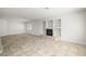 Expansive living room features tile flooring, recessed lighting and a cozy fireplace at 9491 Gainey Ranch Ave, Las Vegas, NV 89147