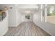 Bright living room featuring wood-look flooring, large windows, and modern lighting at 9491 Gainey Ranch Ave, Las Vegas, NV 89147