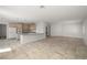 Open-concept living area features tiled flooring, recessed lighting, and a bright kitchen at 9491 Gainey Ranch Ave, Las Vegas, NV 89147