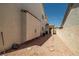 The side yard has gravel, stepping stones, and an access door at 9491 Gainey Ranch Ave, Las Vegas, NV 89147