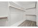 Organized walk-in closet with shelving and wooden rods for ample storage at 9491 Gainey Ranch Ave, Las Vegas, NV 89147