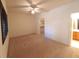 Bright bedroom featuring ceiling fan, neutral paint, adjoining bathroom and walk-in closet at 9580 W Reno Ave # 183, Las Vegas, NV 89148