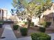 Well-maintained apartment building with landscaped grounds and concrete walkway at 9580 W Reno Ave # 183, Las Vegas, NV 89148