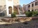 Apartment building featuring manicured landscaping and wrought iron staircases at 9580 W Reno Ave # 183, Las Vegas, NV 89148