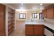 Open concept kitchen features wood cabinets, a breakfast bar, and modern appliances, with views into the dining and living areas at 9580 W Reno Ave # 183, Las Vegas, NV 89148