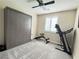 Bedroom with gray carpet, ceiling fan, shuttered windows, and a gray Murphy bed with an exercise area at , Las Vegas, NV 89135