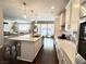 Modern kitchen features a center island, white countertops, and an open layout leading to the living and outdoor spaces at , Las Vegas, NV 89135