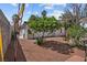 Backyard featuring a mature tree and red Adirondack chairs on pea gravel at 1004 Yucca Ave, Las Vegas, NV 89104