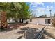 Expansive backyard with a brick patio area, mature trees, and a well-kept lawn at 1004 Yucca Ave, Las Vegas, NV 89104