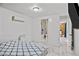 Bright bedroom featuring tile floors, neutral decor, and an ensuite bathroom at 1004 Yucca Ave, Las Vegas, NV 89104