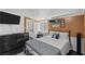 Cozy bedroom with a queen-sized bed, flat-screen tv, and adjacent access to the ensuite bathroom at 1004 Yucca Ave, Las Vegas, NV 89104