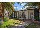 Beautiful single-story home with manicured lawn, palm trees, and stylish black and white design elements on a sunny day at 1004 Yucca Ave, Las Vegas, NV 89104