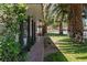 Charming exterior view showcasing lush greenery, mature palm trees, and a welcoming walkway to a beautiful home at 1004 Yucca Ave, Las Vegas, NV 89104