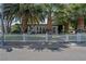 Inviting single-story home with white picket fence and beautiful trees at 1004 Yucca Ave, Las Vegas, NV 89104