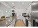 Open concept kitchen with quartz counters, tiled backsplash, and stainless appliances at 1004 Yucca Ave, Las Vegas, NV 89104