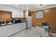 Kitchenette featuring white cabinets, black countertops, tile floors and stainless steel appliances at 1004 Yucca Ave, Las Vegas, NV 89104