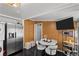 Cozy kitchenette with stainless appliances, a dining area, and a flat-screen television at 1004 Yucca Ave, Las Vegas, NV 89104