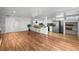Open concept living and kitchen area with hardwood floors and large windows at 1004 Yucca Ave, Las Vegas, NV 89104