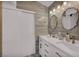 Beautiful bathroom with a dual sink vanity, decorative mirrors, wood look tile, and modern fixtures at 103 Trout Creek Ct, Las Vegas, NV 89123