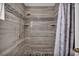 Stylish bathroom shower with wood-look tile, mosaic accents, and modern shower fixtures at 103 Trout Creek Ct, Las Vegas, NV 89123