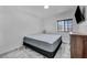 Well-lit bedroom with neutral tones, a queen bed, tiled floors, and a dresser at 103 Trout Creek Ct, Las Vegas, NV 89123