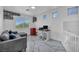 Upstairs bonus room featuring a gray sectional, a desk, and ample natural light at 103 Trout Creek Ct, Las Vegas, NV 89123