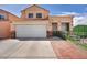 Inviting two-story home with a lush walkway and a two car garage at 103 Trout Creek Ct, Las Vegas, NV 89123