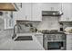 Modern kitchen with stainless steel appliances, white cabinetry, and sleek countertops at 103 Trout Creek Ct, Las Vegas, NV 89123