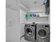 Well-organized laundry room featuring a modern washer and dryer, shelving, and bright lighting for efficient chores at 103 Trout Creek Ct, Las Vegas, NV 89123