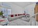 Bright living room featuring high ceilings, large windows, and a comfortable sectional sofa at 103 Trout Creek Ct, Las Vegas, NV 89123