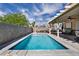 Inviting backyard pool featuring a covered patio area, ideal for relaxing and entertaining in the sun at 103 Trout Creek Ct, Las Vegas, NV 89123