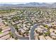 Expansive aerial view of a residential neighborhood with mountain views and well-maintained landscaping at 10601 India Hawthorn Ave, Las Vegas, NV 89144