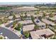 A neat residential area is captured in an aerial view, with houses and desert landscaping at 10601 India Hawthorn Ave, Las Vegas, NV 89144