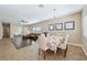 Inviting dining area with large windows, chandelier, and hardwood flooring at 10601 India Hawthorn Ave, Las Vegas, NV 89144