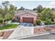 A one-story home with a well-kept lawn, desert landscaping, and an attached two-car garage at 10601 India Hawthorn Ave, Las Vegas, NV 89144