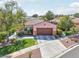 Charming single-Gathering home with an attached garage, desert landscaping, and healthy green lawn at 10601 India Hawthorn Ave, Las Vegas, NV 89144