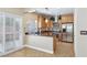 Charming kitchen with stainless steel appliances, stone counters, and tile floors at 10601 India Hawthorn Ave, Las Vegas, NV 89144